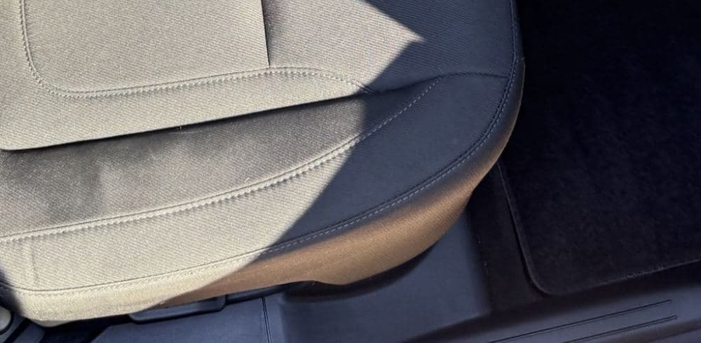 The same seat base, carpet, and door sill after the interior was cleaned
